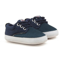 Pair of navy blue children's shoes with white soles 