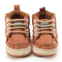 Pair of brown baby shoes with white laces