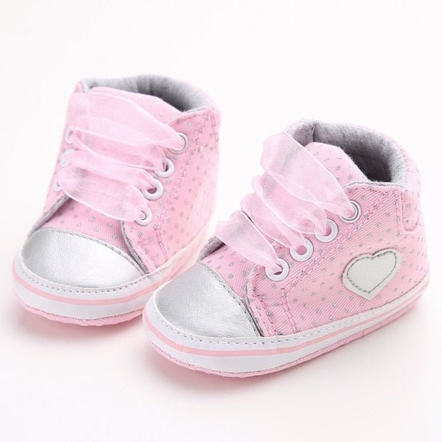 Pink baby shoes with gray soles 