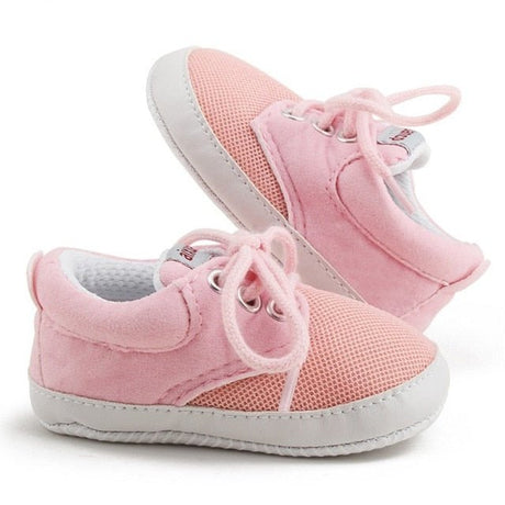 Pink baby shoes with white soles 