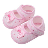 Pair of pink baby shoes with bows 