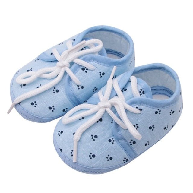 Pair of blue baby shoes with white laces 