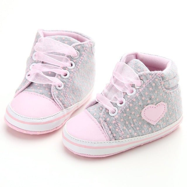 Pair of baby shoes with pink hearts 