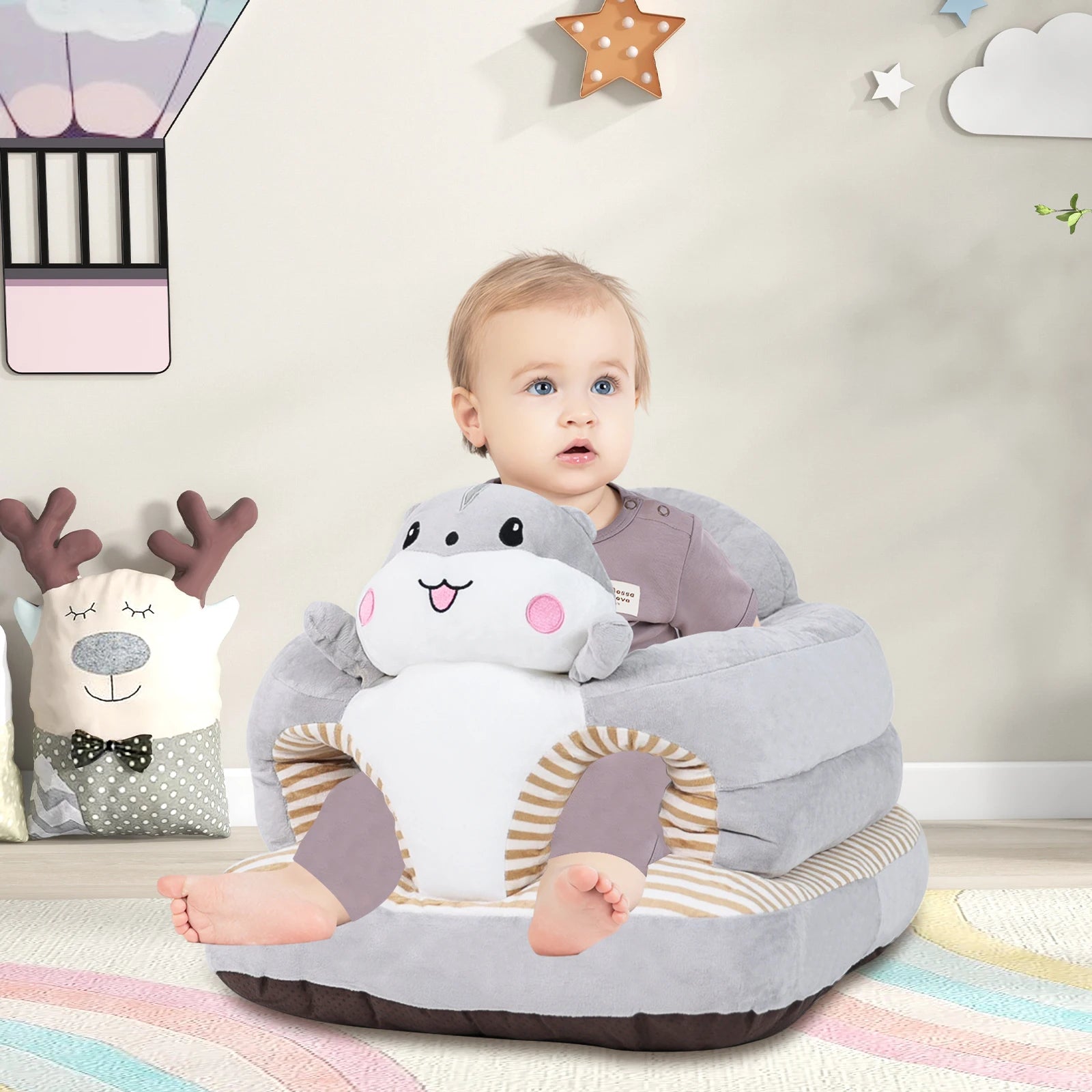 Baby sitting on a shark-shaped infant training seat in a nursery for supported floor play and learning to sit.