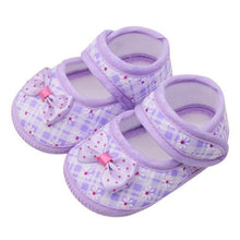 Pair of purple baby shoes with bows 