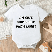 White cotton slogan onesie for babies, a practical newborn gift for daily changes and comfortable sleep.