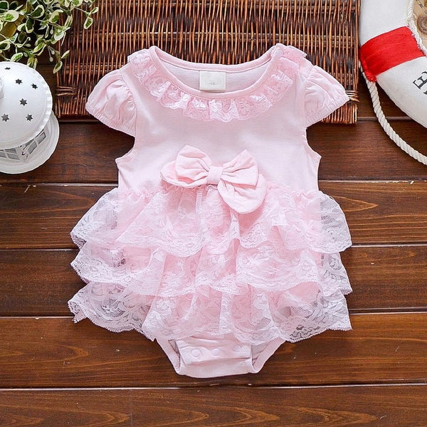 Pink lace baby romper with a bow