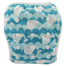 Blue whale print baby swim diaper, a washable toddler swim pant for repeat use through summer swimming sessions.