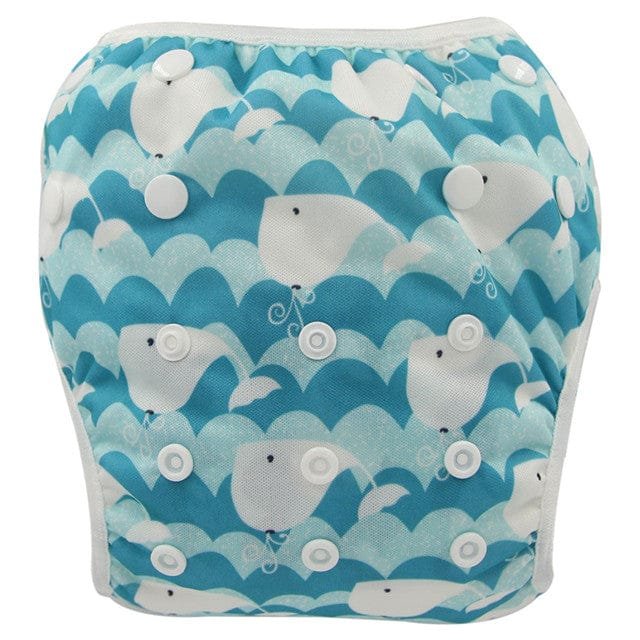Blue whale print baby swim diaper, a washable toddler swim pant for repeat use through summer swimming sessions.