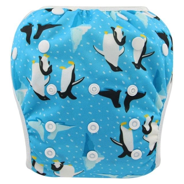 Penguin print baby swim diaper in blue, a waterproof toddler swim nappy for swimming lessons and holiday pool time.