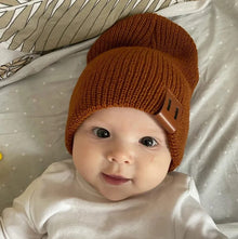 Baby wearing the brown knitted beanie hat for cosy naps, pram walks, and cold-weather photo sessions.