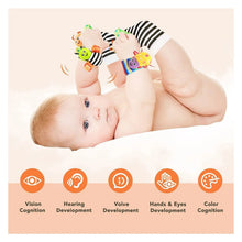 Baby wearing the foot finder socks and wrist rattles from the 4-piece set during tummy time and floor play.