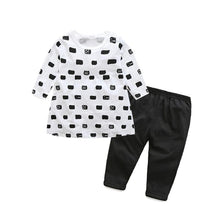 Front view of the white and black print cotton baby tracksuit set worn for family gatherings and outings.