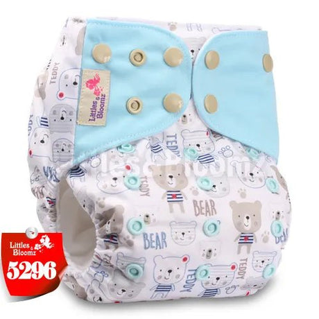 Baby diaper with bear pattern and blue bow, branded 'Littles & Bloomz'.