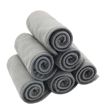 Happy Flute bamboo charcoal cloth diaper liners rolled and stacked for daily nappy changes.