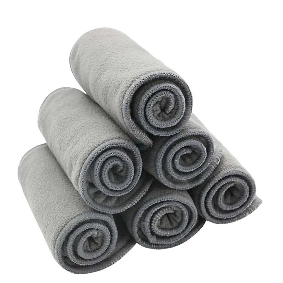 Happy Flute bamboo charcoal cloth diaper liners rolled and stacked for daily nappy changes.