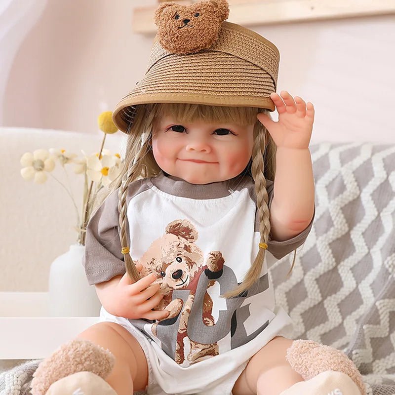Bath friendly waterproof Reborn Doll with curly hair in a teddy straw hat for indoor pretend play and bathing routines.