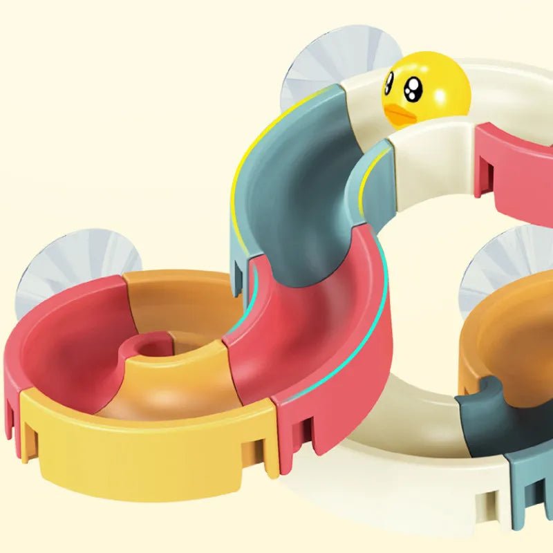 Colorful toy track with a small yellow duck-like figure.