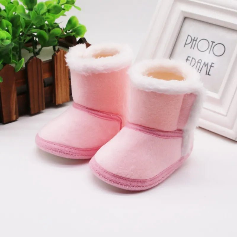 Baywell camel autumn winter newborn boots with soft sole and fur lining, worn on a baby's foot for cozy baby wear from 0 to 18 months.