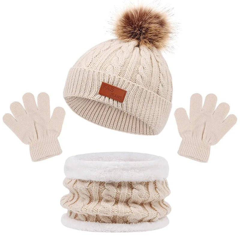 Beige knit hat with brown pom-pom, matching gloves, and cable knit scarf on a white background