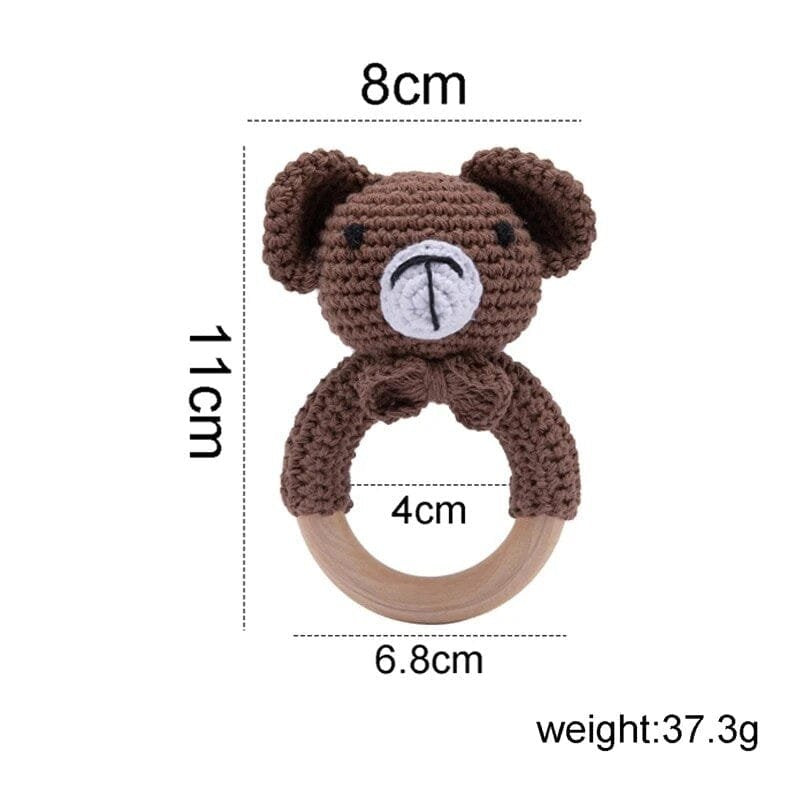 Bear head crochet baby rattle and teether wooden ring close-up, a soft toy for infant grasping and chewing.