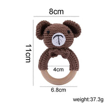 Bear head crochet baby rattle and teether wooden ring close-up, a soft toy for infant grasping and chewing.
