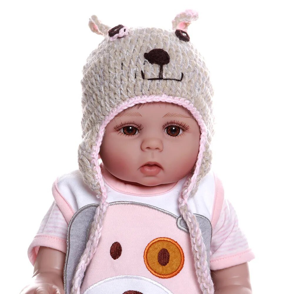 48CM Bebe Doll wearing a bear-themed outfit and hat, a bath-friendly silicone doll for newborn gifting and play.