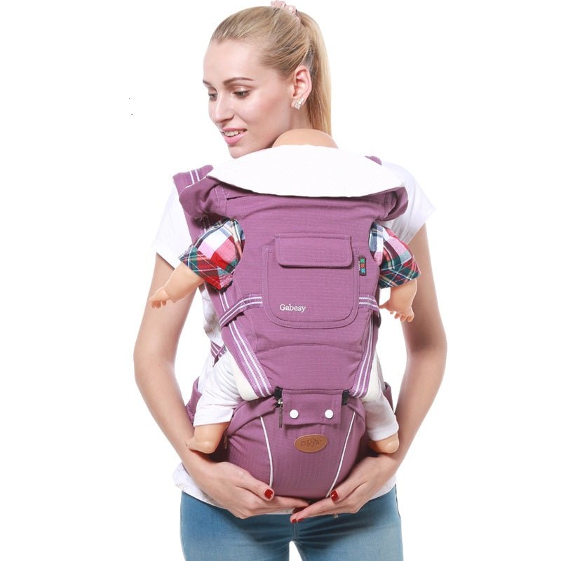 Woman using a purple baby carrier 