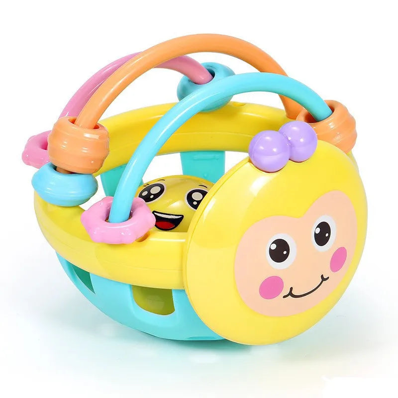 Yellow bee rattle ball teether in an angled view with pink and teal bead rings