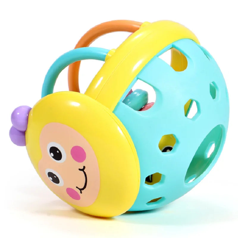 Side view of the yellow bee rattle ball showing the teal base with round holes