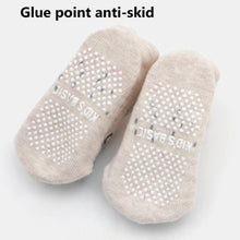Beige baby socks with anti-skid dot soles for safe walking on tiled and wooden floors.