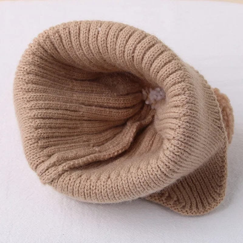 Beige knitted baby headband from the winter bear collection, a soft ear-warming accessory for stroller walks and nursery photos.