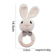 Beige rabbit crochet baby rattle and teether wooden ring, a neutral handmade toy for teething and nursery gifting.