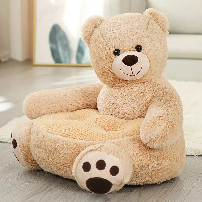Beige teddy bear plush baby seat sofa in a styled room for toddler seating, nursery decoration, and quiet play.
