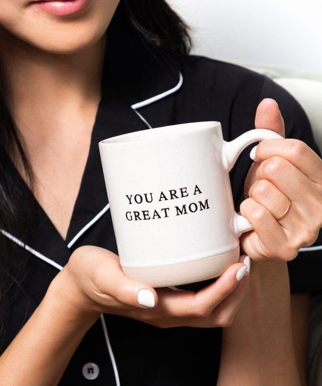 Person holding a mug with 'YOU ARE A GREAT MOM' text
