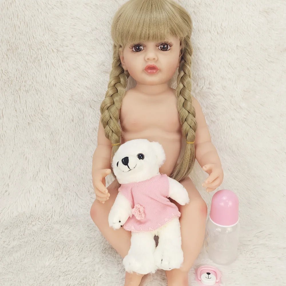 Naked doll with braided hair holding a teddy bear