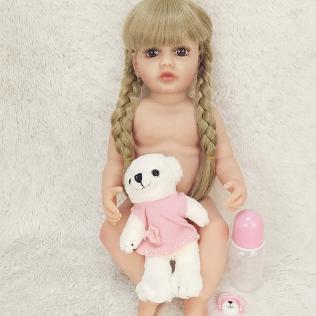 Naked doll with braided hair holding a teddy bear