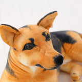 Close-up of a plush dog toy with brown and black fur on a white background