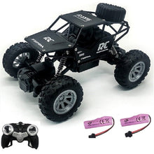 Black 4WD RC monster truck with battery pack and remote handset for confident high-speed outdoor driving.