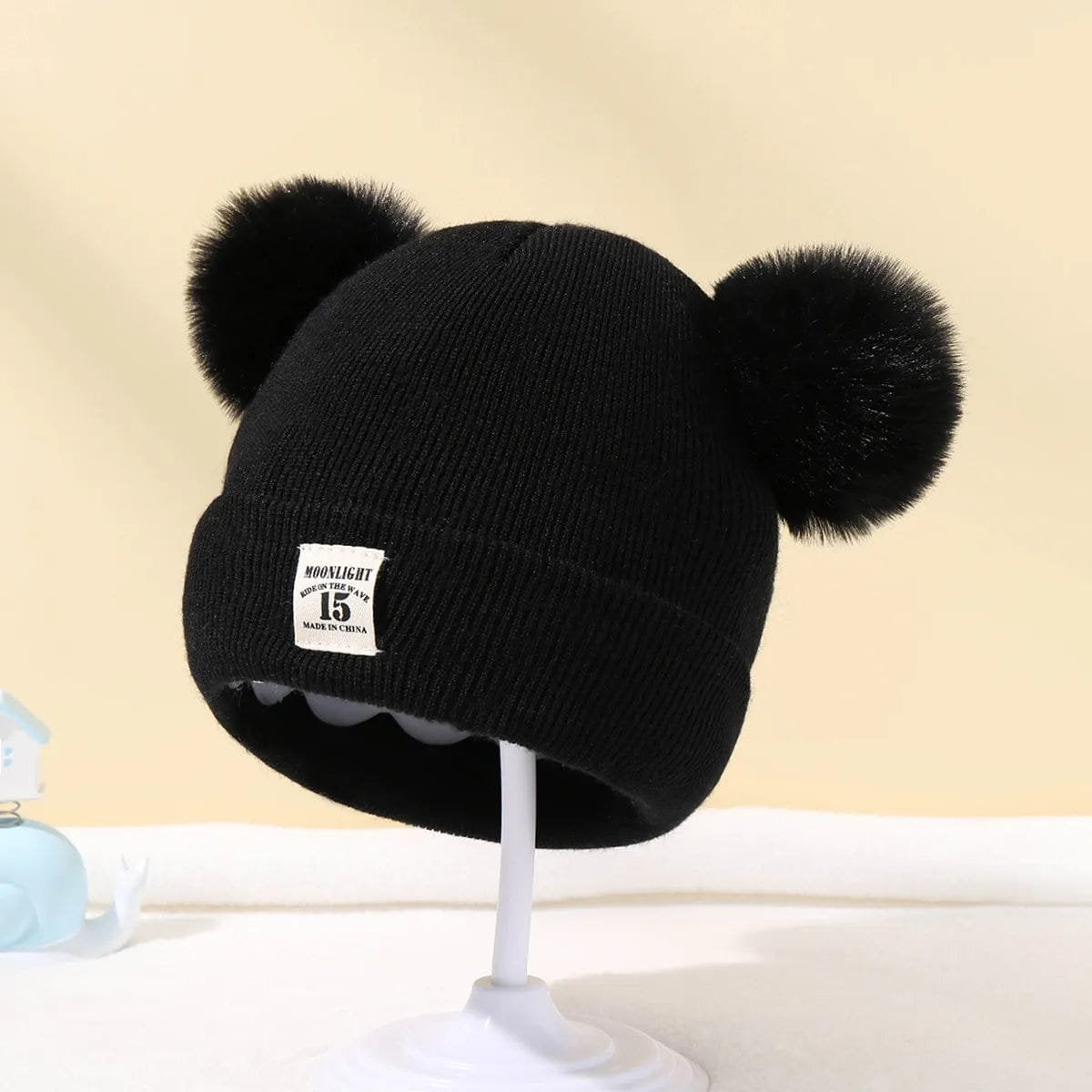 Black Warm Knitted Baby Beanie with fluffy pom poms for winter warmth on stroller rides and family outings.