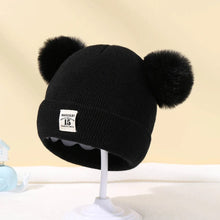 Black Warm Knitted Baby Beanie with fluffy pom poms for winter warmth on stroller rides and family outings.
