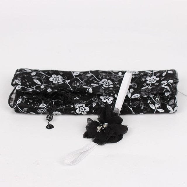 Black floral newborn wrap and headband prop from an alternate view for styled baby photography.