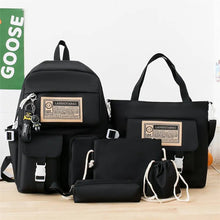 Black Harajuku Kawaii anime laptop bag set on a wooden table for students carrying tech and textbooks daily.