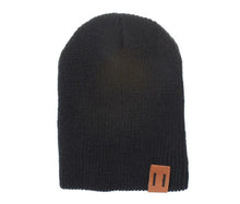 Black knitted baby beanie hat in solid crochet for unisex kids winter wear and everyday warmth.