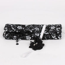 Black lace newborn wrap and flower headband photo prop for styled studio baby portrait sessions.