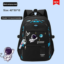 Side view of the black orthopedic boys primary school backpack with space graphic and padded carrying straps.