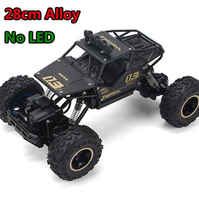 Black off-road RC truck with large wheels built for rugged 4WD terrain driving.
