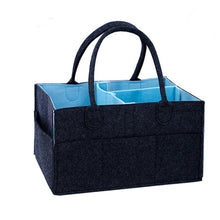 Black fabric tote with blue lining offering large capacity storage for the changing table.