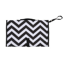 Black and white chevron baby diaper bag with shoulder strap for hands-free carrying on walks and shopping trips.
