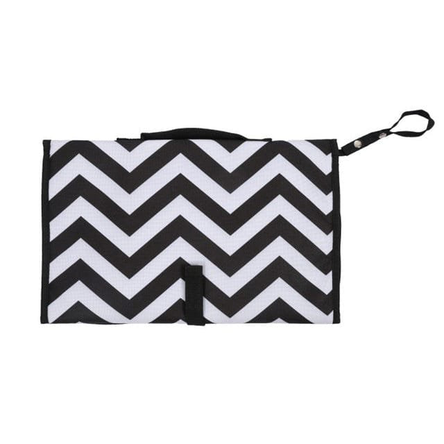 Black and white chevron baby diaper bag with shoulder strap for hands-free carrying on walks and shopping trips.